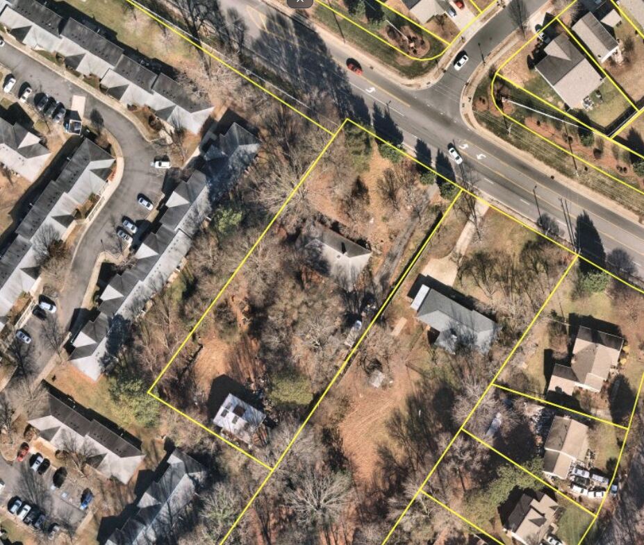 Aerial view of 7214 Lawyers Rd, Charlotte NC, shown adjacent to a 19-unit townhome development on the west side of the parcel.