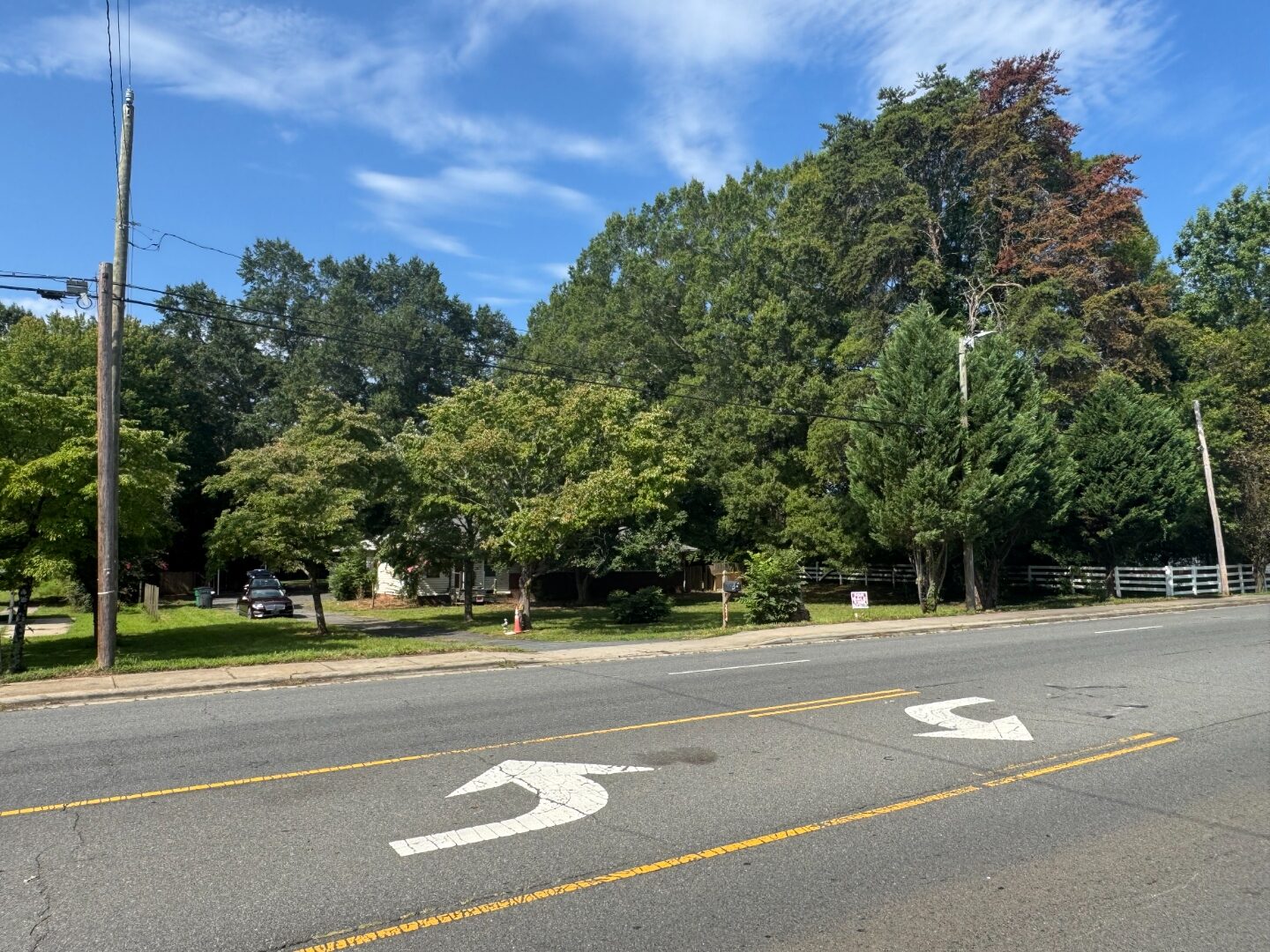 Four-lane Lawyers Road corridor with turn lanes in front of the parcel.